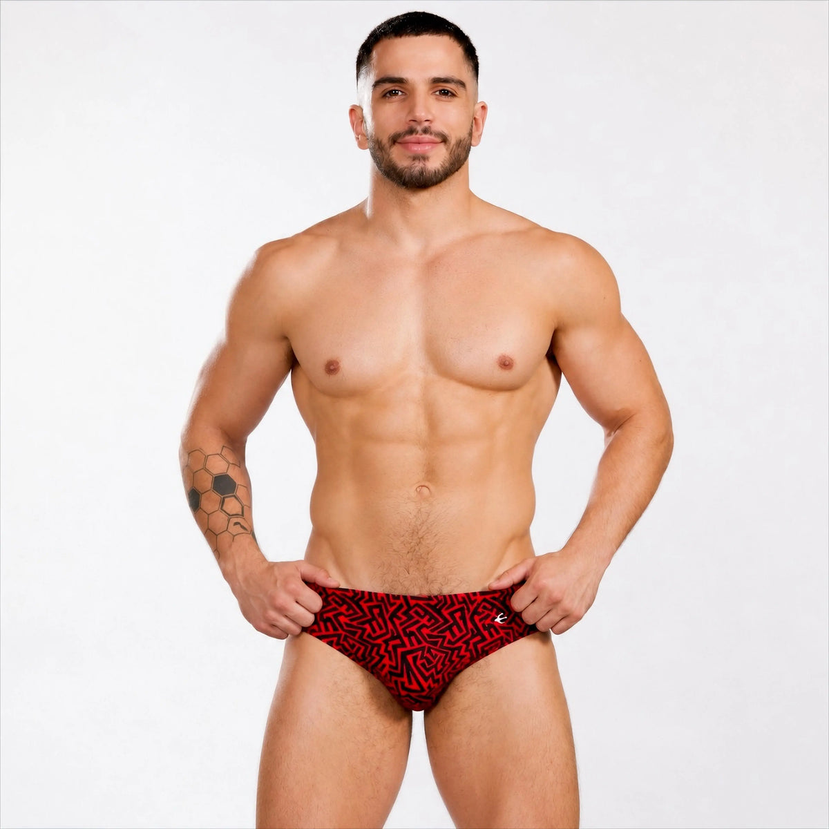 Men's swim briefs, front view with red Grecas print by Equal Swimwear.